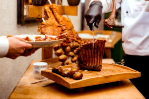cook cuts fried ribs on cutting desk